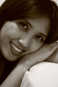 Close-up portrait of a smiling young woman