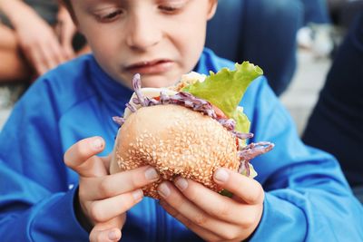 Close-up of boy holding burger