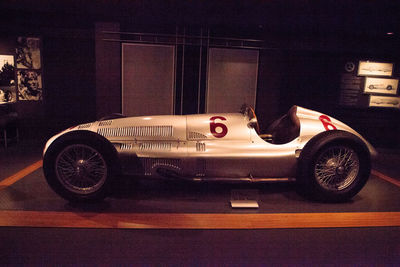 Side view of vintage car on street at night