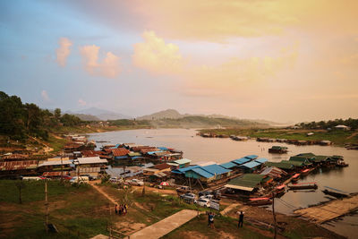 High angle view of houses and buildings against sky during sunset