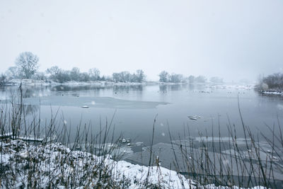 Scenic view of frozen lake against sky during winter