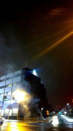 Illuminated buildings against sky at night