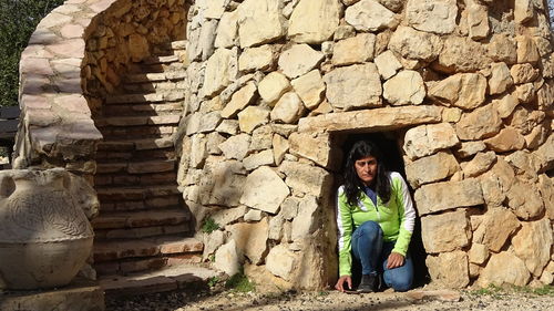 Portrait of young woman  against rock formations