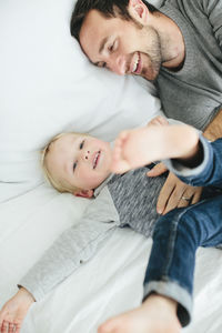 Father with son playing in bedroom