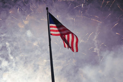 Low angle view of flag flags against sky