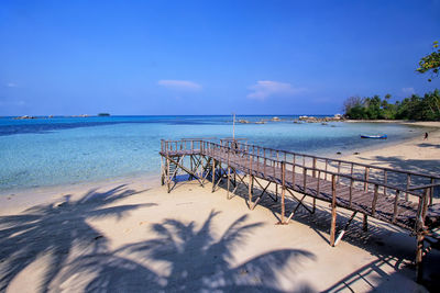 Scenic view of beach against blue sky