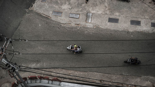High angle view of people sitting on building