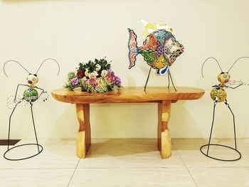 Potted plant on table against wall