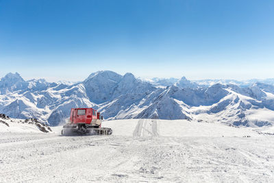 Scenic view of snowcapped mountains against clear blue sky