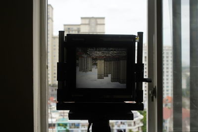 Rear view of woman looking through window