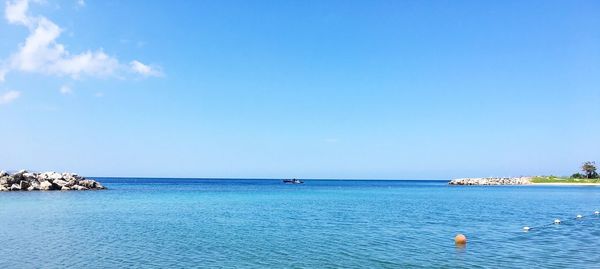 Scenic view of sea against blue sky