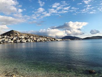 Scenic view of sea and mountains against sky