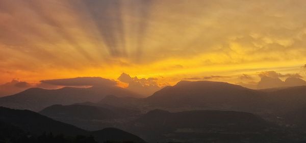 Scenic view of mountains against sky during sunset