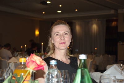 Portrait of woman with drink in restaurant