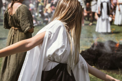 Rear view of people standing outdoors