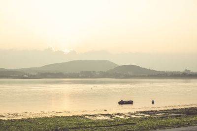Scenic view of lake against sky during sunset