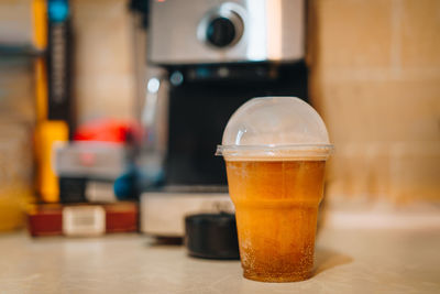 Close-up of coffee glass on table