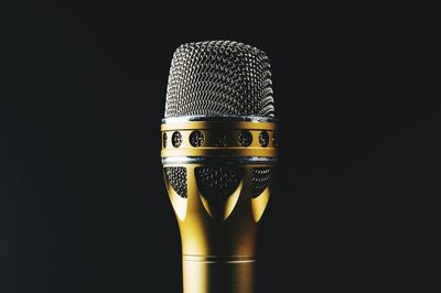 Close-up of a microphone against black background