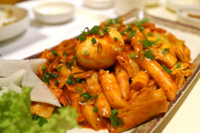 Close-up of pasta with egg in plate on table