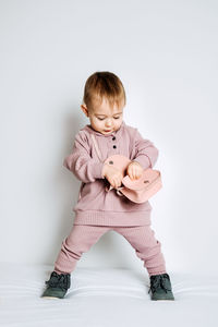Baby fashion. unisex clothes for babies. cute baby in cotton set suit on light background.