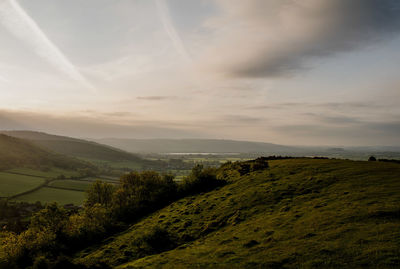 Scenic view of landscape against cloudy sky