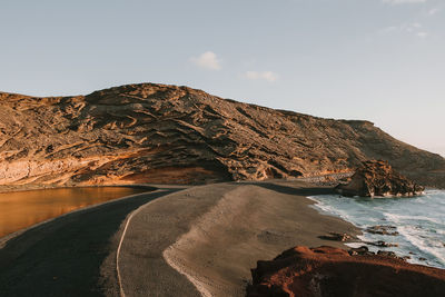 Scenic view of sea and mountains against sky