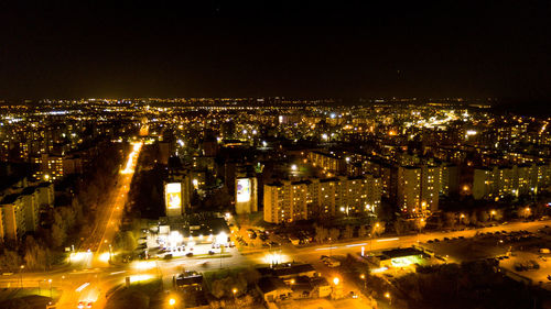 High angle view of city lit up at night