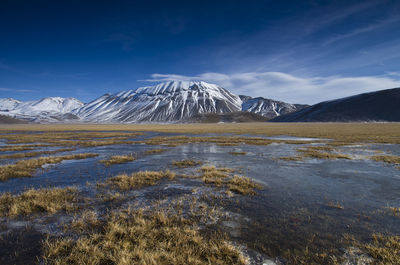 Scenic view of snowcapped mountains against sky