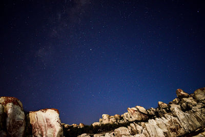 Low angle view of rock formation against sky at night