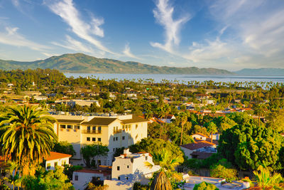 High angle view of townscape by sea against sky
