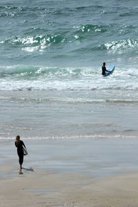 People surfing on beach