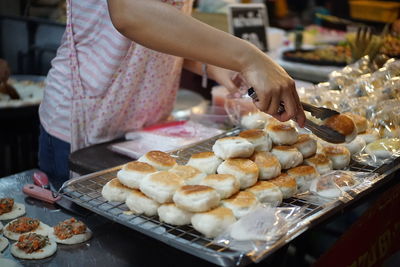 Midsection of woman preparing food in kitchen