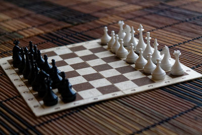 Close-up of chess pieces on place mat