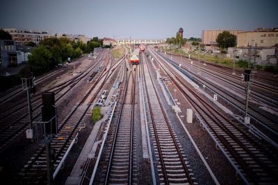 High angle view of train on railroad tracks in city against sky