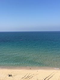 Scenic view of sea against clear blue sky