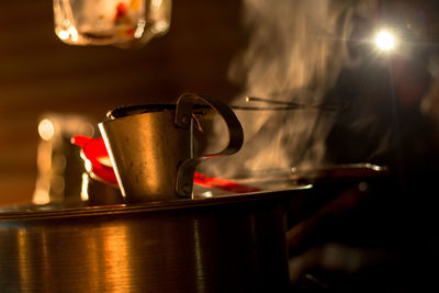 Tea cup on metallic container at night