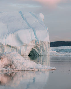 Ice floating on sea against sky during winter