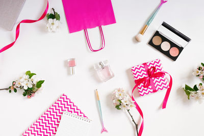 Women's workplace of a fashion blogger. cosmetics, a gift box with a bow and notebooks