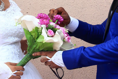 Close-up of hand holding bouquet of people