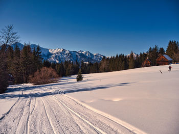 Scenic view of snowcapped mountains against clear blue sky