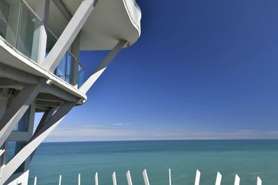 Low angle view of bridge against blue sky