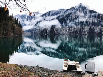 Scenic view of lake by trees against sky