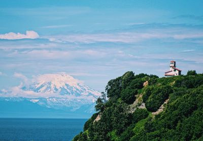 Scenic view of sea and mountain against sky