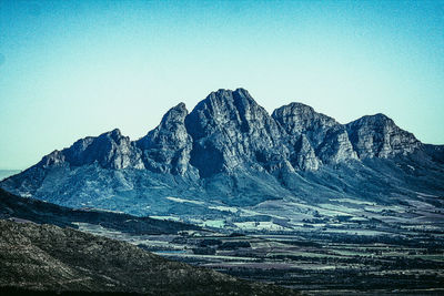 Scenic view of snowcapped mountains against clear blue sky