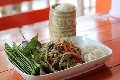 Close-up of papaya salad served on table