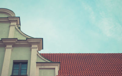 Low angle view of roof against cloudy sky