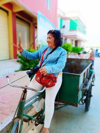 Smiling woman selling products on bicycle