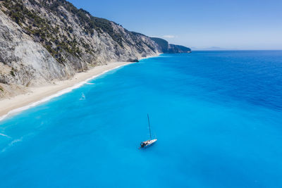 Sailboat in sea against clear sky