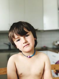 Portrait of shirtless boy at home