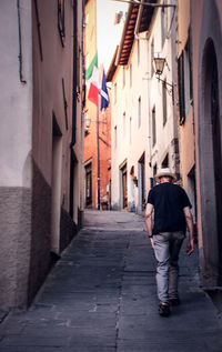 Full length rear view of man walking in city